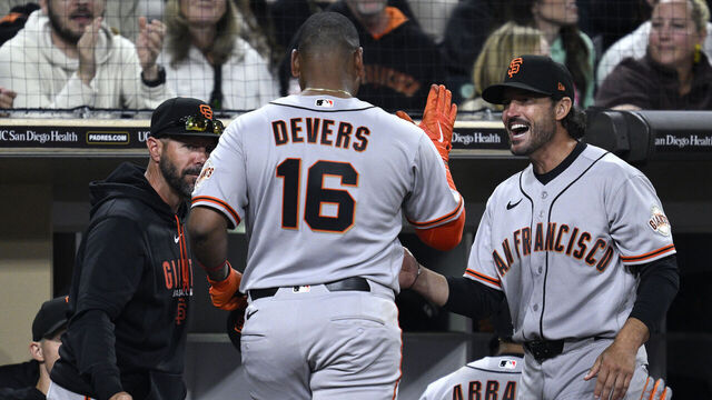 SAN DIEGO, CALIFORNIA - MARCH 31: Rafael Devers #16 of the San Francisco Giants is congratulated at the dugout by manager Tony Vitello #23 during the sixth inning against the San Diego Padres at Petco Park on March 31, 2026 in San Diego, California.