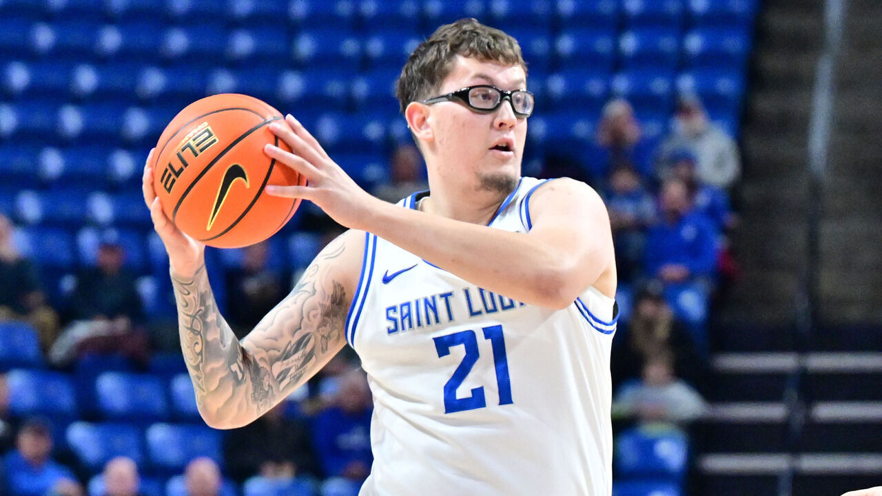 ST. LOUIS, MO - NOVEMBER 10: Saint Louis center Robbie Avila (21) holds the ball as Lindenwood center Milos Nenadic (7) defends during a basketball game between the Lindenwood Lions and the Saint Louis University Billikens on Nov. 10, 2025, at Chaifetz Arena in St. Louis, MO.