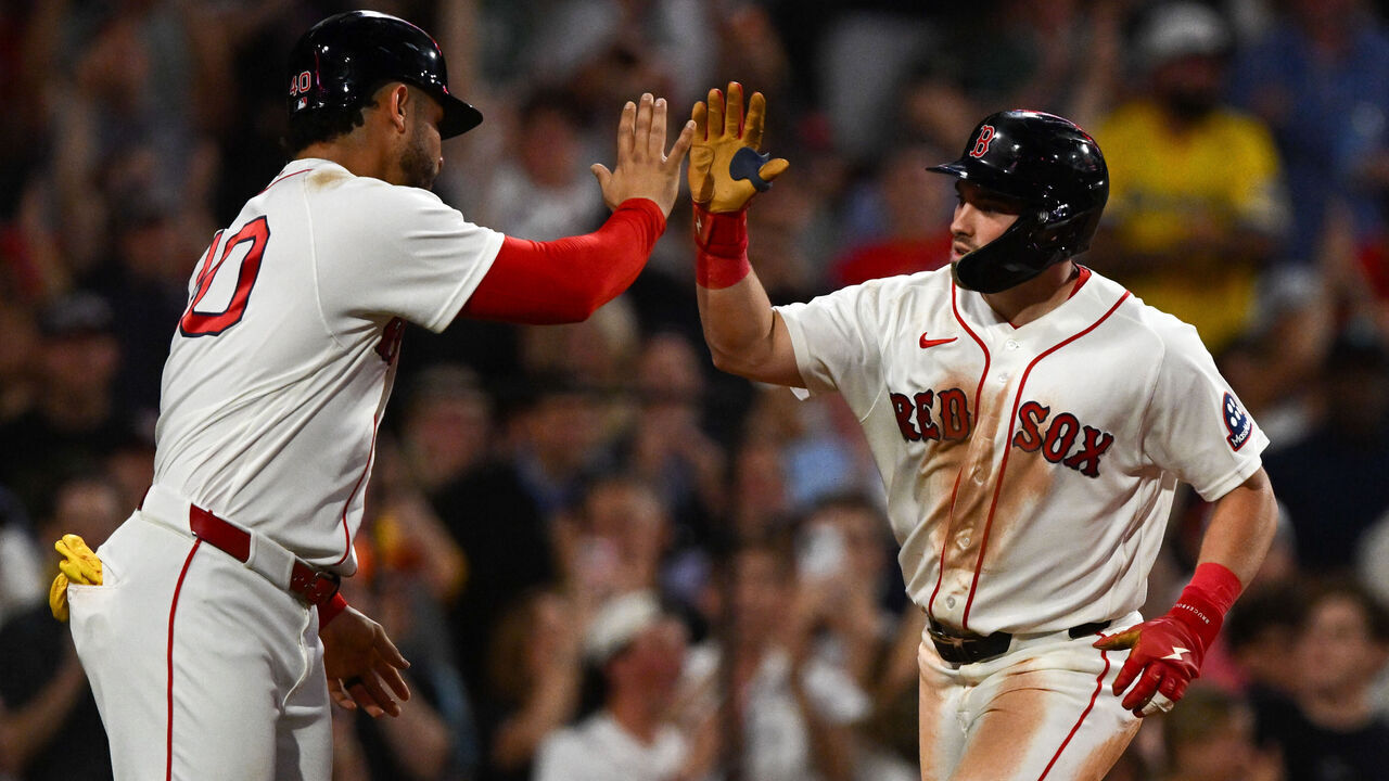 BOSTON, MASSACHUSETTS - JUNE 25: Caleb Durbin #5 of the Boston Red Sox high-fives Willson Contreras #40 after hitting a two-run home run against the New York Yankees during the fifth inning at Fenway Park on June 25, 2026 in Boston, Massachusetts.
