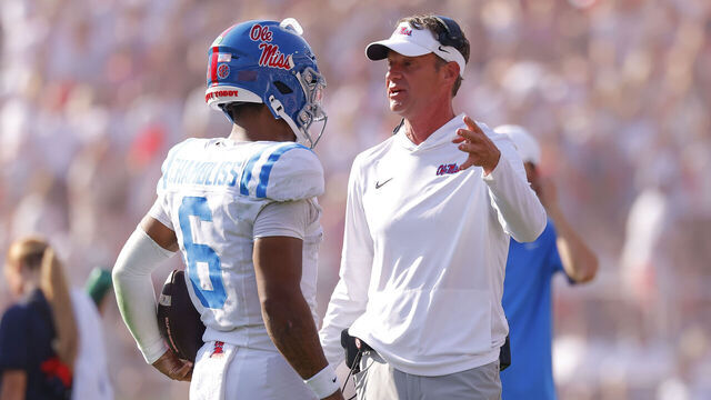 ATHENS, GEORGIA - OCTOBER 18: Head coach Lane Kiffin of the Mississippi Rebels speaks with Trinidad Chambliss #6 during the second quarter against the Georgia Bulldogs at Sanford Stadium on October 18, 2025 in Athens, Georgia.