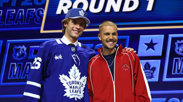 BUFFALO, NEW YORK - JUNE 26: (L-R) Gavin McKenna of Canada and singer Justin Bieber look on after McKenna was drafted by the Toronto Maple Leafs with the first overall pick during day one of the 2026 NHL Draft on June 26, 2026 in Buffalo, New York.