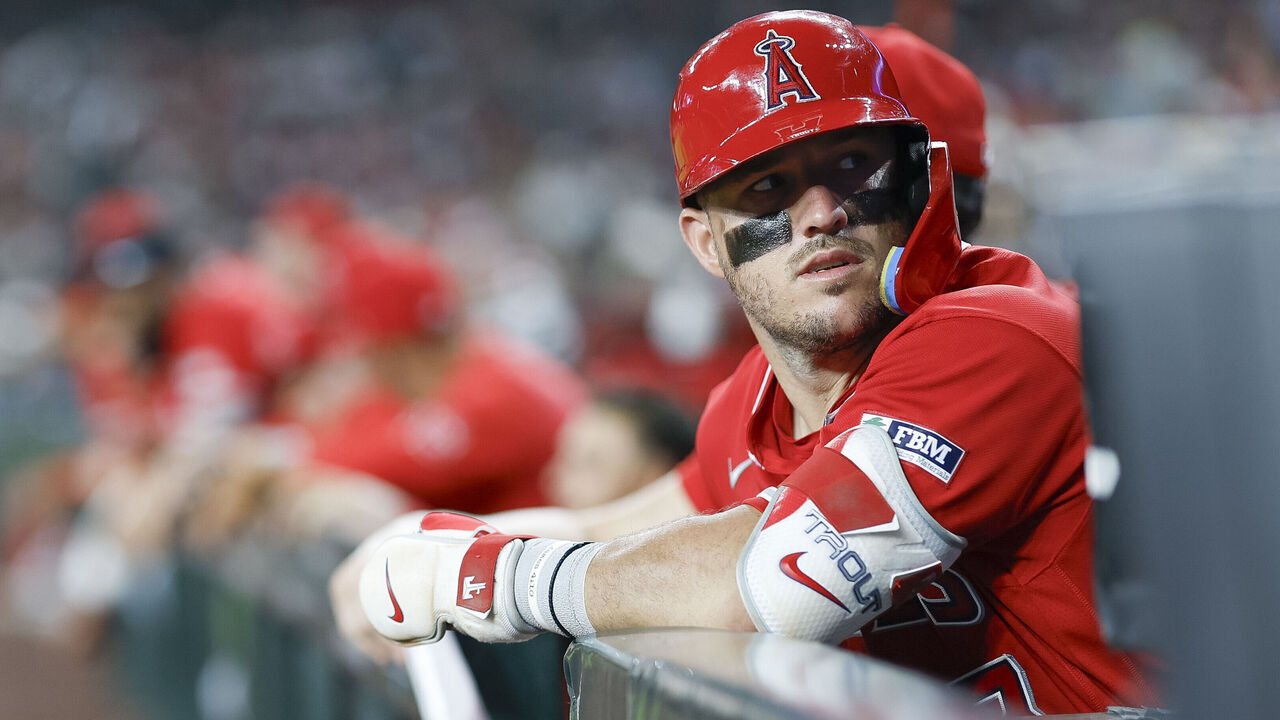 PHOENIX, ARIZONA - JUNE 16: Mike Trout #27 of the Los Angeles Angels looks on from the dugout in the eighth inning during a game against the Arizona Diamondbacks at Chase Field on June 16, 2026 in Phoenix, Arizona.