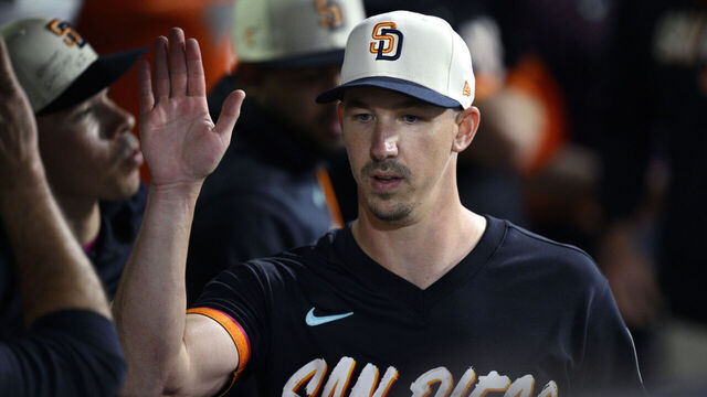 SAN DIEGO, CALIFORNIA - JUNE 26: Walker Buehler #10 of the San Diego Padres is greeted in the dugout after a pitching change in the sixth inning against the Los Angeles Dodgers at Petco Park on June 26, 2026 in San Diego, California.