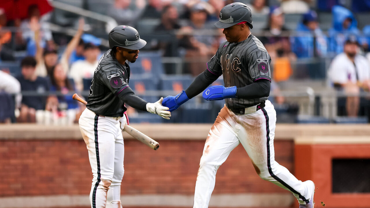 NEW YORK, NEW YORK - JUNE 27: Juan Soto #22 of the New York Mets high fives Francisco Lindor #12 after scoring in the seventh inning at Citi Field on June 27, 2026 in New York City.