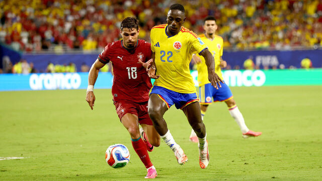 MIAMI GARDENS, FLORIDA - JUNE 27: Pedro Neto #18 of Portugal and Deiver Machado #22 of Colombia compete for the ball during the FIFA World Cup 2026 Group K match between Colombia and Portugal at Miami Stadium on June 27, 2026 in Miami Gardens, Florida.