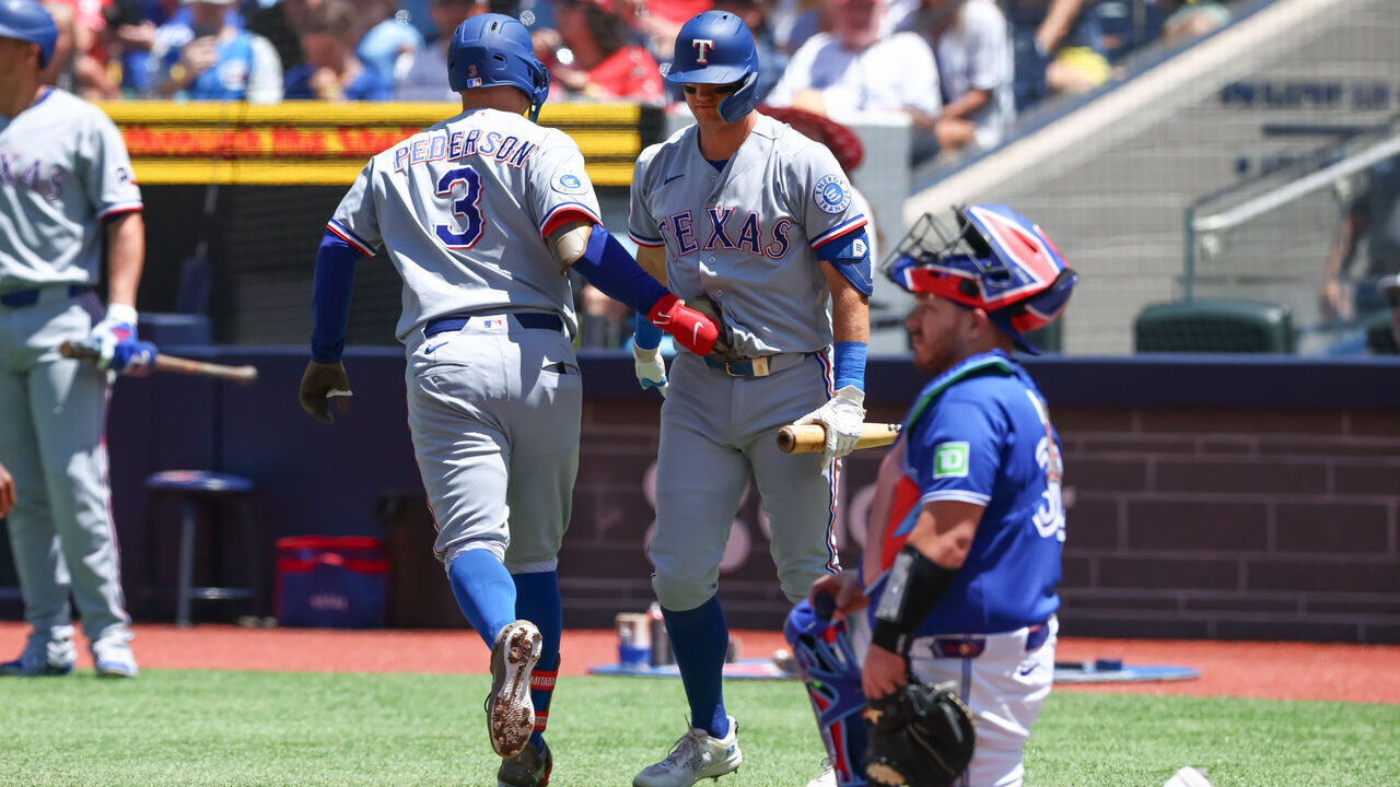 TORONTO, CANADA - JUNE 28: Joc Pederson #3 of the Texas Rangers celebrates at home plate with Josh Jung #6 after hitting a solo-home run in the first inning of their MLB game against the Toronto Blue Jays at Rogers Centre on June 28, 2026 in Toronto, Canada.
