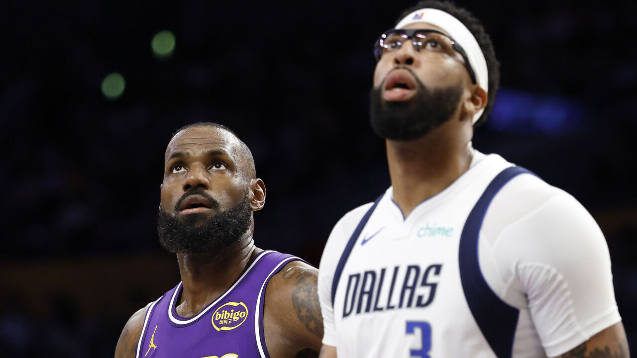 LOS ANGELES, CALIFORNIA - NOVEMBER 28: LeBron James #23 of the Los Angeles Lakers and Anthony Davis #3 of the Dallas Mavericks look on during the second quarter of a game at Crypto.com Arena on November 28, 2025 in Los Angeles, California.