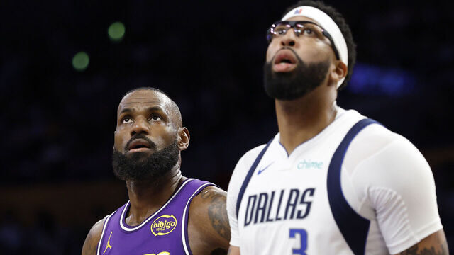 LOS ANGELES, CALIFORNIA - NOVEMBER 28: LeBron James #23 of the Los Angeles Lakers and Anthony Davis #3 of the Dallas Mavericks look on during the second quarter of a game at Crypto.com Arena on November 28, 2025 in Los Angeles, California.