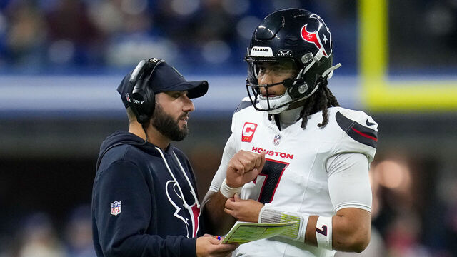 INDIANAPOLIS, INDIANA - NOVEMBER 30: C.J. Stroud #7 of the Houston Texans meets with offensive coordinator Nick Caley in the fourth quarter against the Indianapolis Colts at Lucas Oil Stadium on November 30, 2025 in Indianapolis, Indiana.