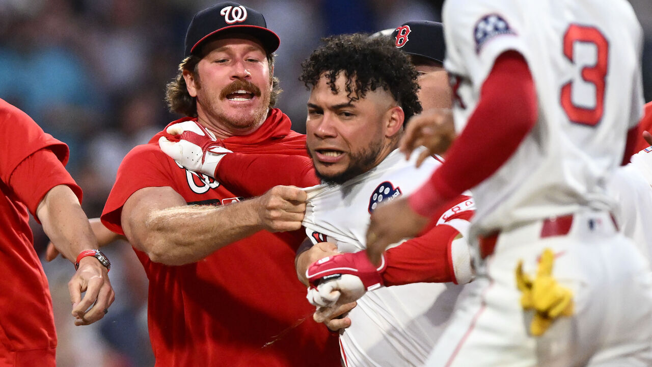 BOSTON, MASSACHUSETTS - JUNE 30: Willson Contreras #40 of the Boston Red Sox is held back after an altercation against the Washington Nationals during the fourth inning at Fenway Park on June 30, 2026 in Boston, Massachusetts.