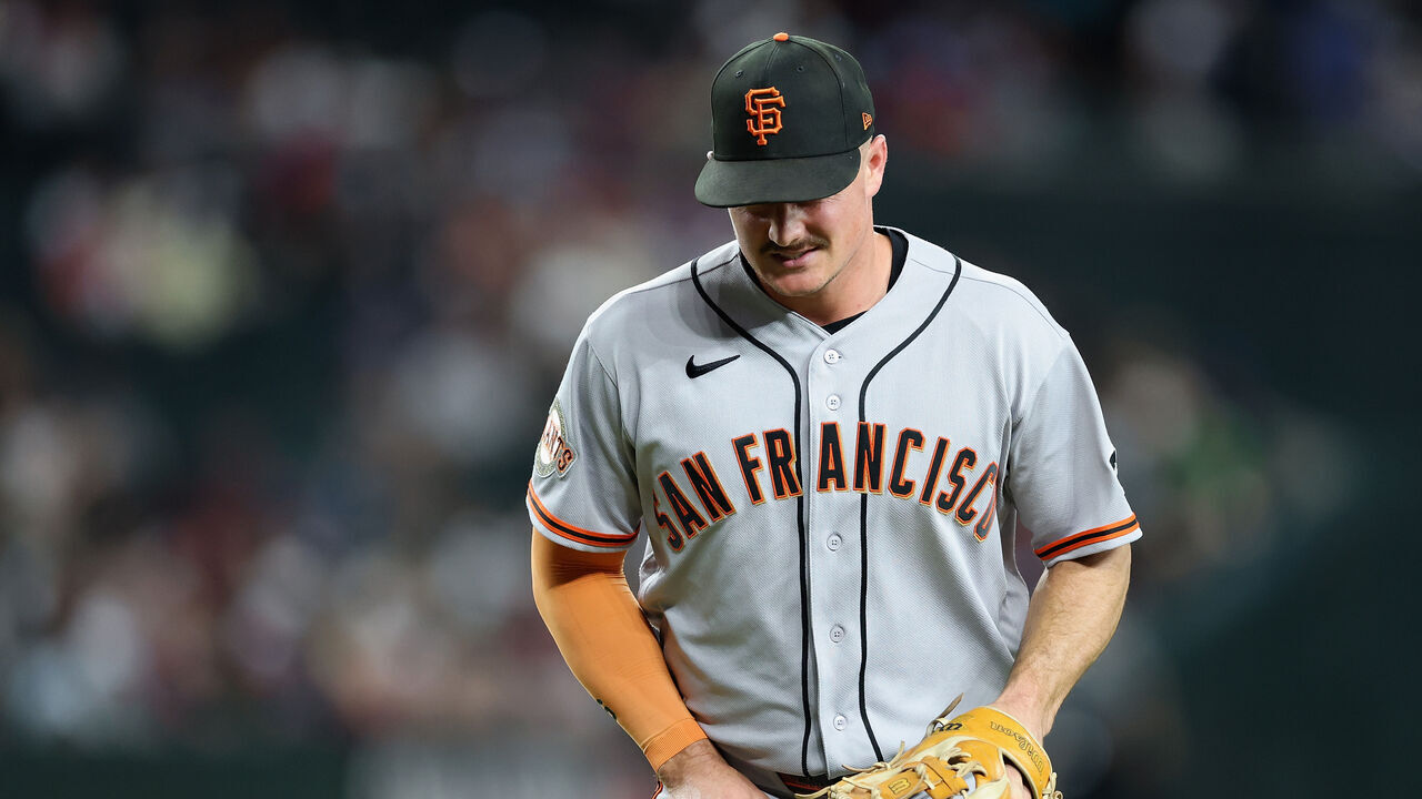 PHOENIX, ARIZONA - JUNE 30: Matt Chapman #26 of the San Francisco Giants reacts in pain after fielding a ground-ball out against the Arizona Diamondbacks during the sixth inning of the MLB game at Chase Field on June 30, 2026 in Phoenix, Arizona.