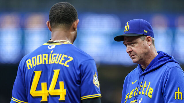 SEATTLE, WASHINGTON - JULY 02: Manager Dan Wilson of the Seattle Mariners (R) checks on Julio Rodriguez #44 during the first inning against the Los Angeles Angels at T-Mobile Park on July 02, 2026 in Seattle, Washington.