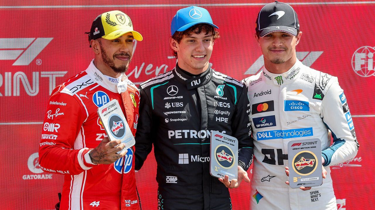 NORTHAMPTON, ENGLAND - JULY 4: Lewis Hamilton of Great Britain and Scuderia Ferrari, Andrea Kimi Antonelli of Italy and Mercedes AMG Petronas F1 Team, and Lando Norris of Great Britain and McLaren Mastercard F1 Team on the podium during the Sprint ahead of the F1 Grand Prix of Great Britain at Silverstone Circuit on July 4, 2026 in Northampton, United Kingdom.