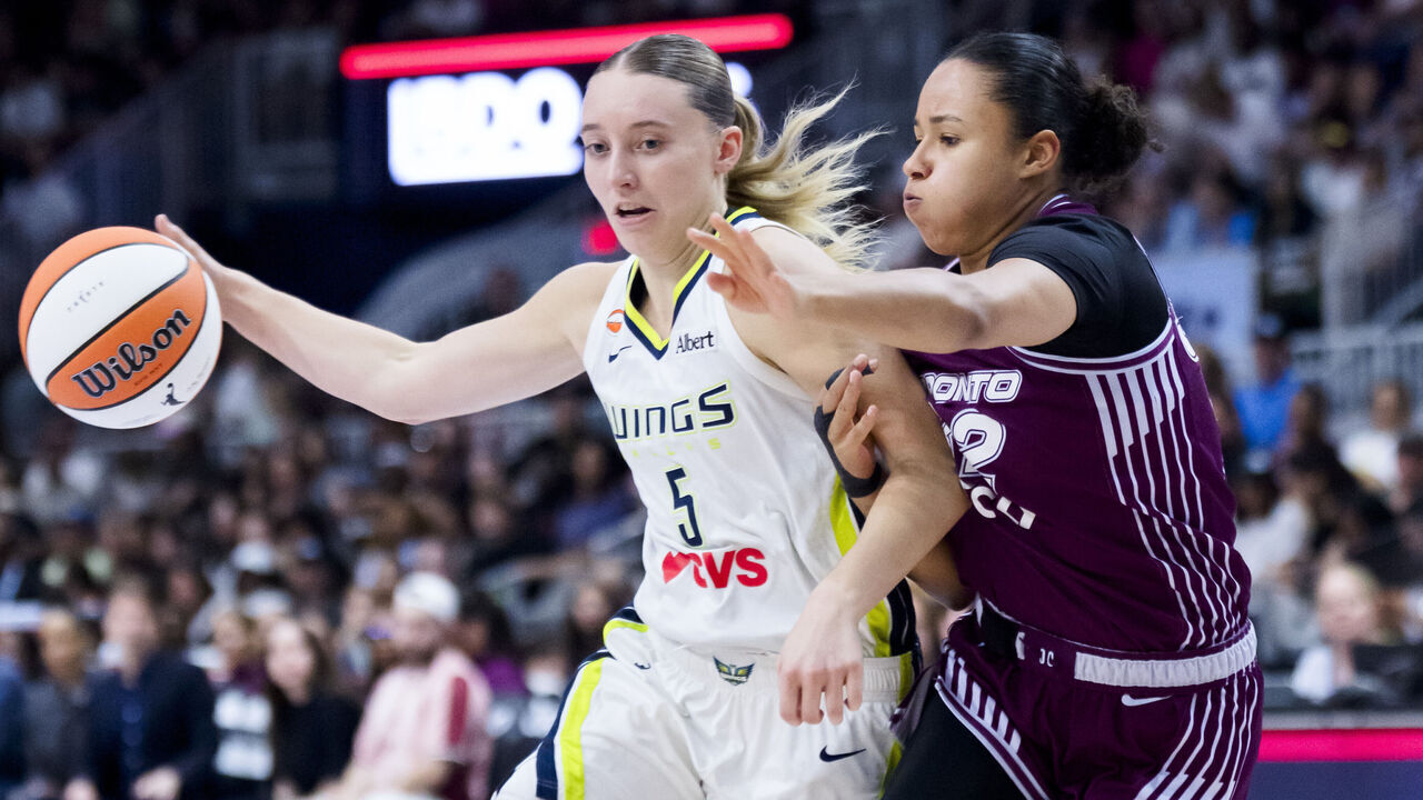 TORONTO, CANADA - JULY 5: Paige Bueckers #5 of the Dallas Wings drives against Tima Pouye #32 of the Toronto Tempo during the second half of their WNBA basketball game at the Coca-Cola Coliseum on July 5, 2026 in Toronto, Ontario, Canada. NOTE TO USER: User expressly acknowledges and agrees that, by downloading and/or using this Photograph, user is consenting to the terms and conditions of the Getty Images License Agreement.