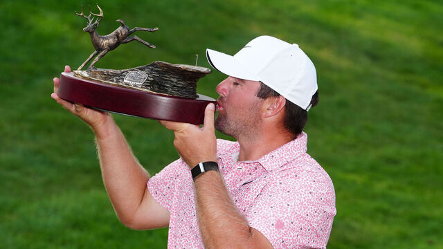 SILVIS, IL - JULY 05: PGA golfer Chris Gotterup poses kisses the trophy after winning the John Deere Classic on July 5, 2026, at TPC Deere Run in Silvis, Illinois.
