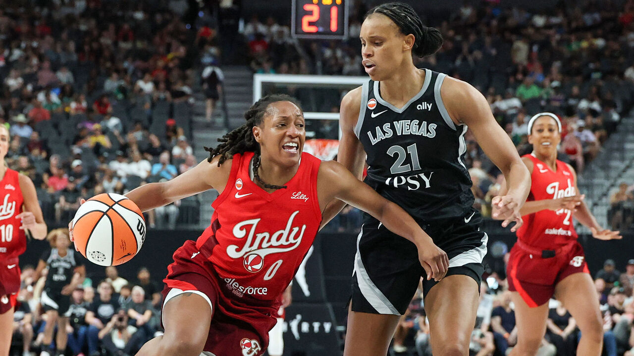 LAS VEGAS, NEVADA - JULY 05: Kelsey Mitchell #0 of the Indiana Fever drives against Brianna Turner #21 of the Las Vegas Aces in the fourth quarter of their game at T-Mobile Arena on July 05, 2026 in Las Vegas, Nevada. The Fever defeated the Aces 84-68.