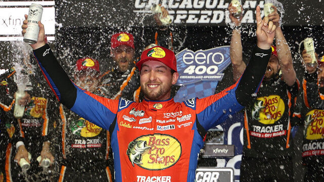 JOLIET, ILLINOIS - JULY 05: Chase Briscoe, driver of the #19 Bass Pro Shops Toyota, celebrates in victory lane after winning the NASCAR Cup Series eero 400 at Chicagoland Speedway on July 05, 2026 in Joliet, Illinois.