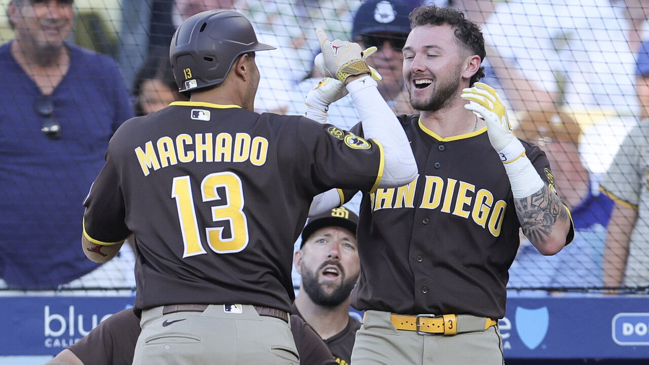LOS ANGELES, CALIFORNIA - JULY 05: Manny Machado #13 of the San Diego Padres celebrates with Jackson Merrill #3 after hitting a three-run home run during the seventh inning against the Los Angeles Dodgers at Dodger Stadium on July 05, 2026 in Los Angeles, California.