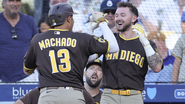 LOS ANGELES, CALIFORNIA - JULY 05: Manny Machado #13 of the San Diego Padres celebrates with Jackson Merrill #3 after hitting a three-run home run during the seventh inning against the Los Angeles Dodgers at Dodger Stadium on July 05, 2026 in Los Angeles, California.