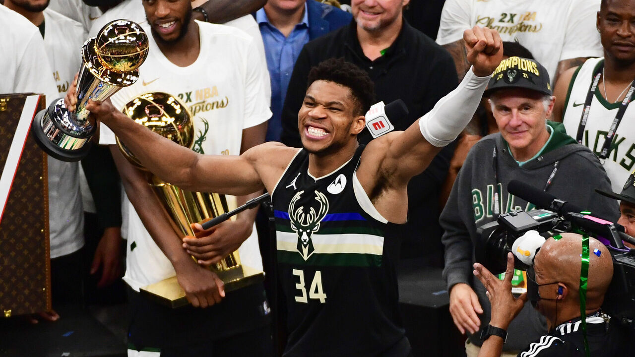 MILWAUKEE, WI - JULY 20: Giannis Antetokounmpo #34 of the Milwaukee Bucks celebrates while holding the Bill Russell NBA Finals Most Valuable Player Award after the game against the Phoenix Suns during Game Six of the 2021 NBA Finals on July 20, 2021 at the Fiserv Forum in Milwaukee, Wisconsin. Mandatory Copyright Notice: Copyright 2021 NBAE .