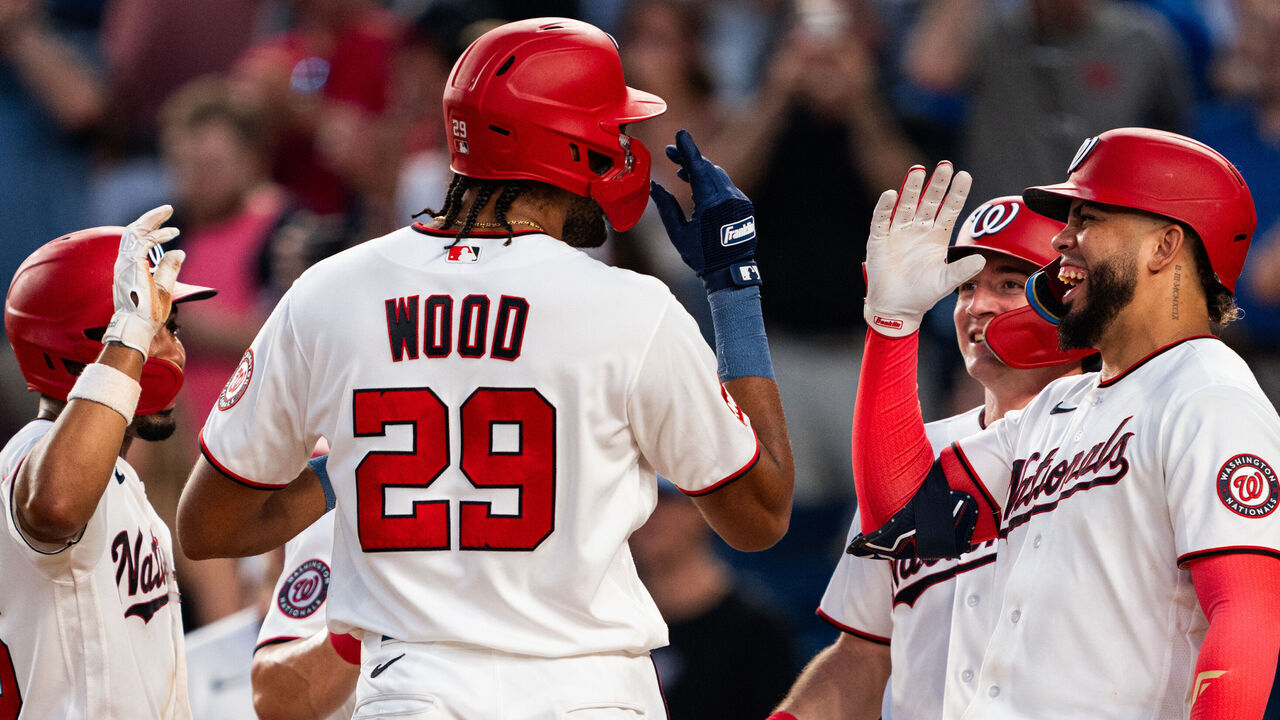 WASHINGTON, DC - JULY 06: Nasim Nuñez #26, Jacob Young #30 and Luis García Jr. #2 of the Washington Nationals celebrate with #James Wood #29 at home plate after he hit a grand slam home run in the fifth inning during a game against the Houston Astros at Nationals Park on July 06, 2026 in Washington, DC.