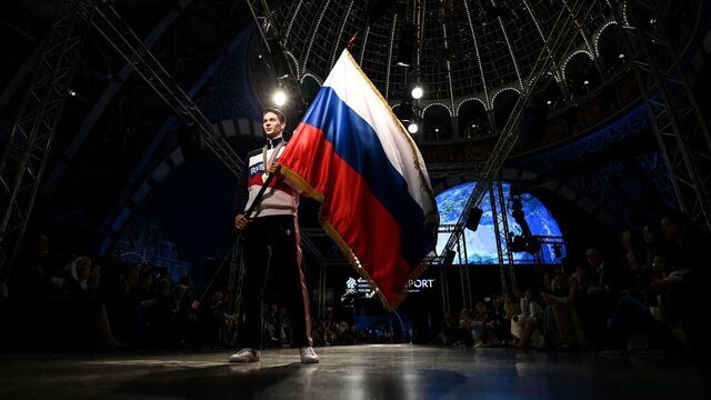 A model holding a Russian flag presents the Russian Olympic Team uniform for the Tokyo 2020 Olympic Games, designed and manufactured by ZASPORT clothing company, in Moscow on April 14, 2021.
