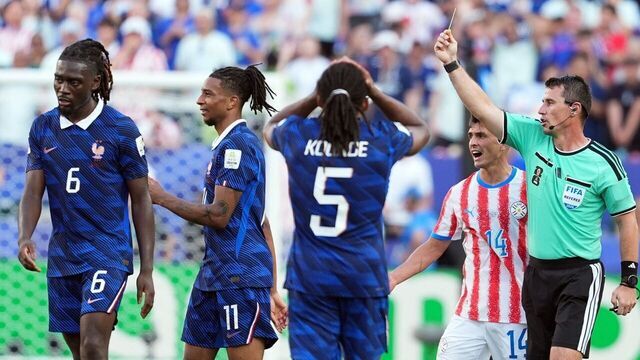 Michael Olise 2nd L of France is shown a yellow card by Referee Ilgiz Tantashev 1st R during the round of 16 match between France and Paraguay at the 2026 FIFA World Cup at Philadelphia Stadium in Philadelphia, the United States, July 4, 2026.