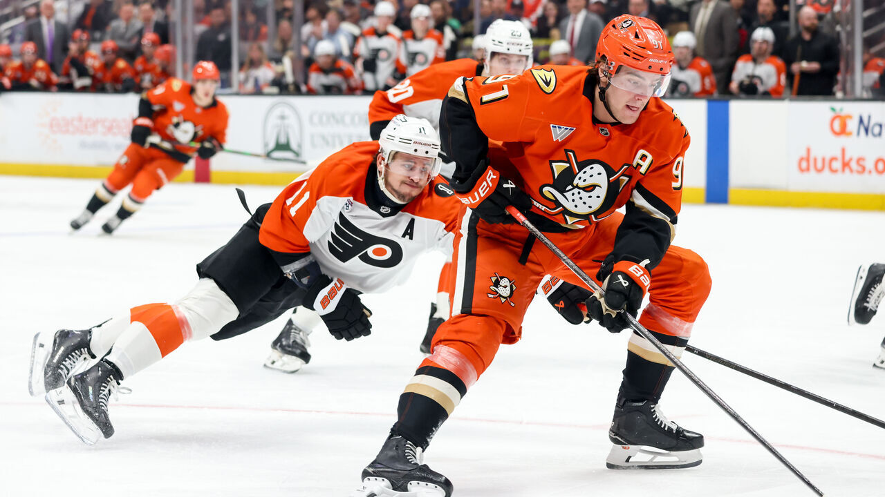 ANAHEIM, CA - MARCH 18: Leo Carlsson #91 of the Anaheim Ducks skates with the puck with pressure from Travis Konecny #11 of the Philadelphia Flyers during the third period at Honda Center on March 18, 2026 in Anaheim, California.