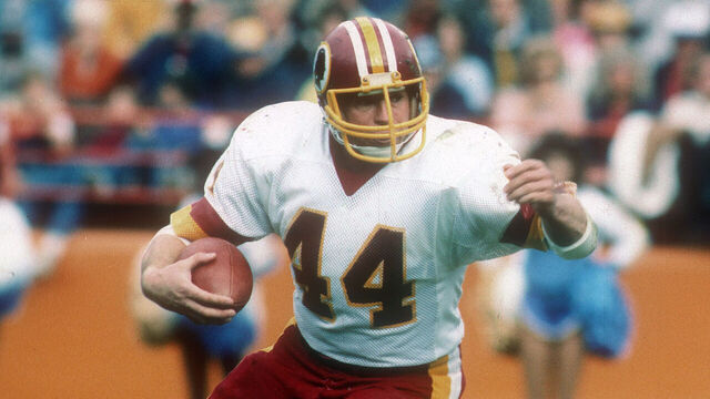 ANAHEIM, CA - NOVEMBER 20: Running back John Riggins #44 of the Washington Redskins carries the ball against the Los Angeles Rams during an NFL football game November 20, 1983 at Anaheim Stadium in Anaheim, California. Riggins played for the Redskins from 1976-85.