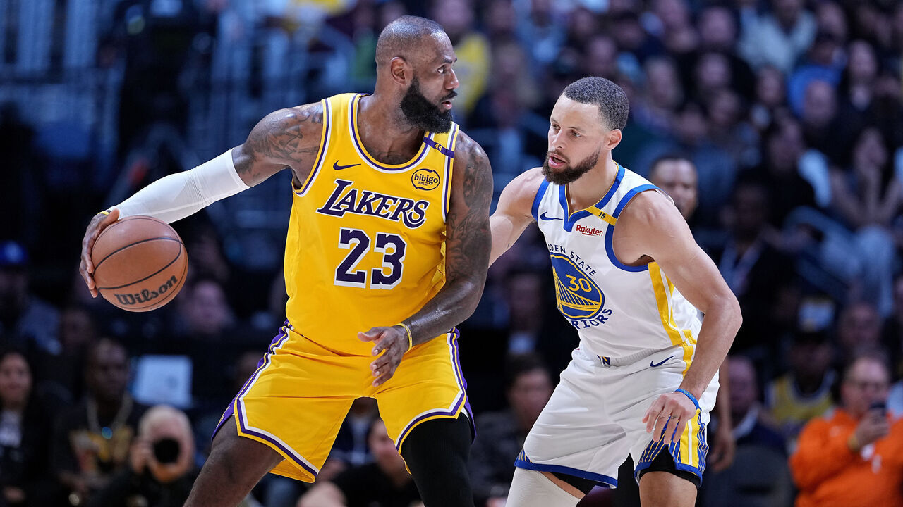LOS ANGELES, CALIFORNIA - APRIL 03: LeBron James #23 of the Los Angeles Lakers controls the ball against Stephen Curry #30 of the Golden State Warriors during the second half of a game at Crypto.com Arena on April 03, 2025 in Los Angeles, California.