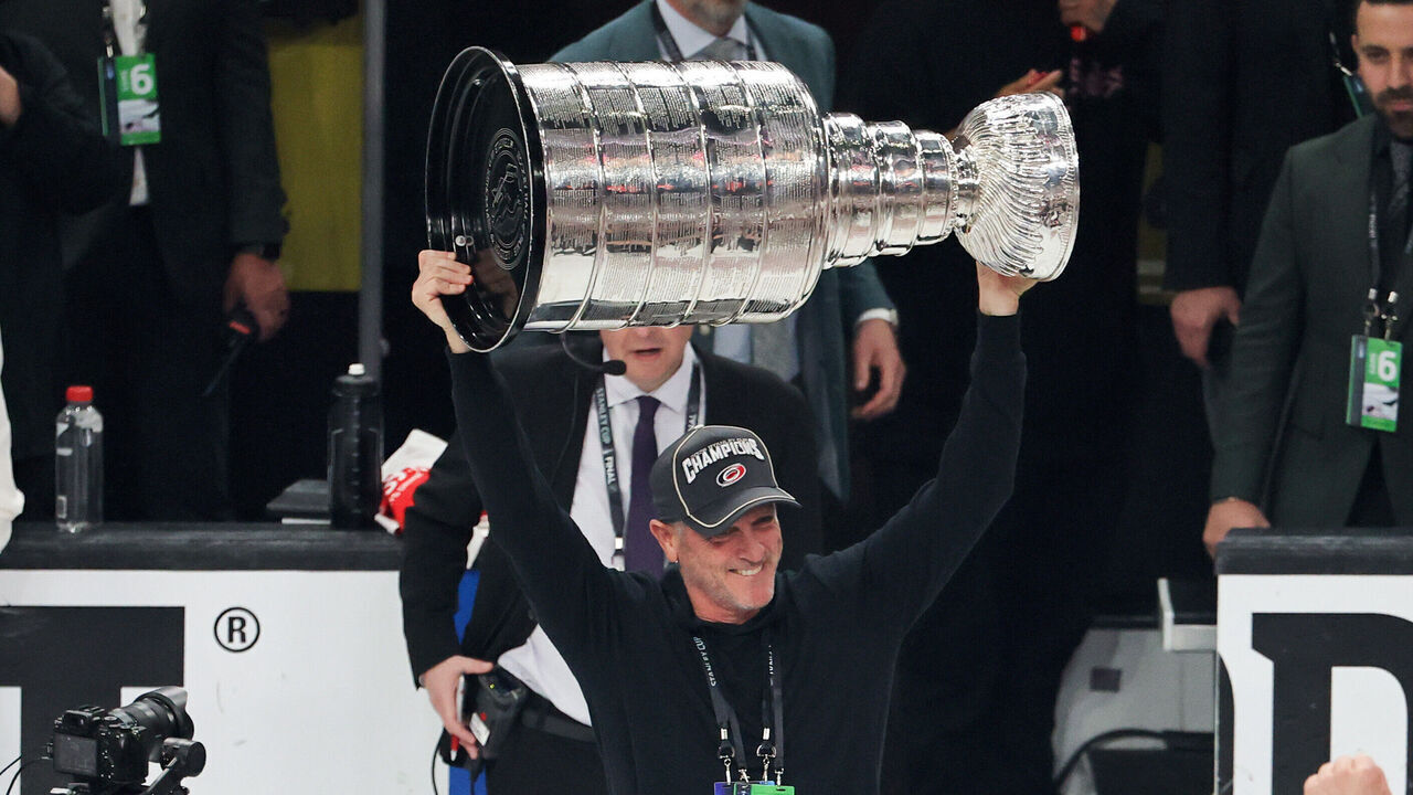 LAS VEGAS, NEVADA - JUNE 14: CEO, owner and governor Tom Dundon of the Carolina Hurricanes hoists the Stanley Cup after the team's 3-0 victory over the Vegas Golden Knights in Game Six of the 2026 NHL Stanley Cup Final at T-Mobile Arena on June 14, 2026 in Las Vegas, Nevada. The Hurricanes won the series four games to two.