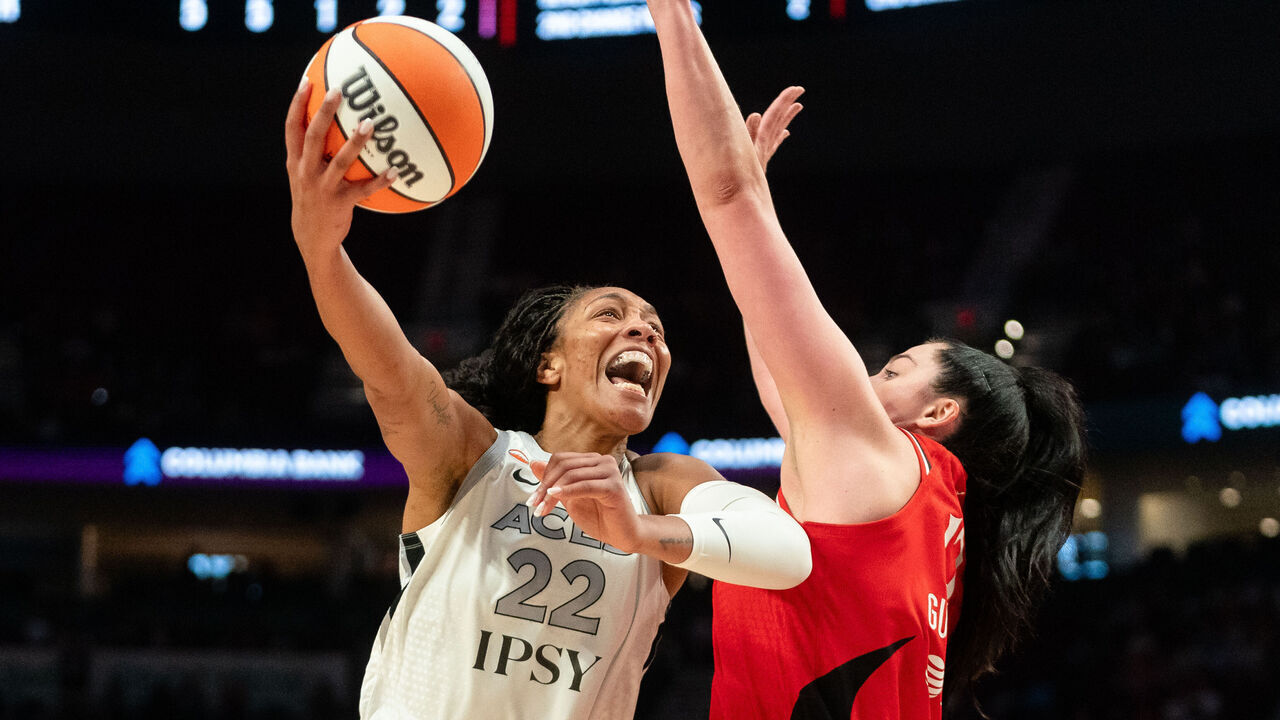 PORTLAND, OREGON - JULY 9: A'ja Wilson #22 of the Las Vegas Aces attempts a layup against Megan Gustafson #17 of the Portland Fire during the second half of the game at Moda Center on July 9, 2026 in Portland, Oregon.