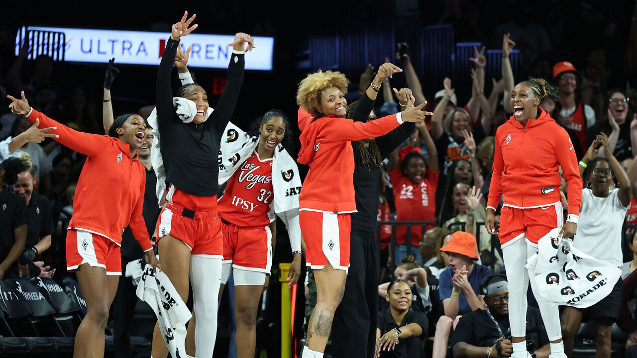 LAS VEGAS, NEVADA - JULY 11: (L-R) Jackie Young #0, A'ja Wilson #22, Cheyenne Parker-Tyus #32, NaLyssa Smith #3 and Chelsea Gray #12 of the Las Vegas Aces react on the bench after Justine Pissott #13 of the Aces hit a 3-pointer against the Phoenix Mercury in the fourth quarter of their game at Michelob ULTRA Arena on July 11, 2026 in Las Vegas, Nevada. The Aces defeated the Mercury 106-58.