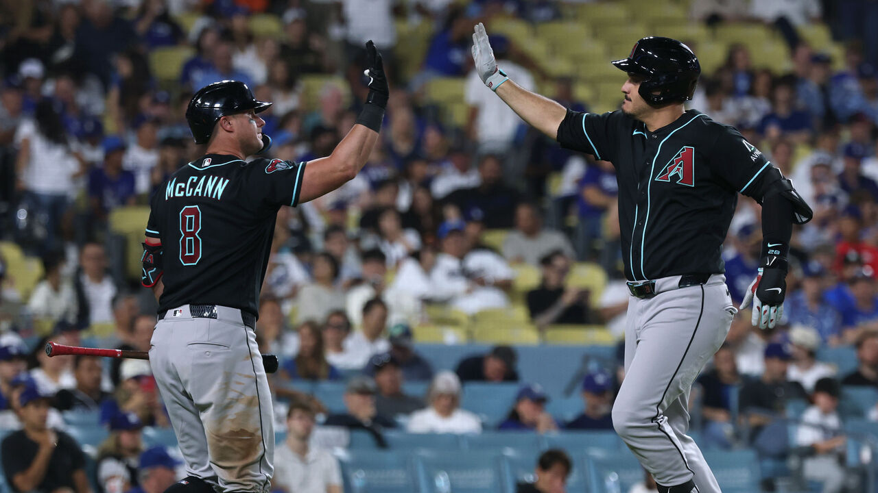LOS ANGELES, CALIFORNIA - JULY 11: Nolan Arenado #28 of the Arizona Diamondbacks celebrates his solo home run with James McCann #8, to take an 8-2 lead over the Los Angeles Dodgers, during the eighth inning at Dodger Stadium on July 11, 2026 in Los Angeles, California.