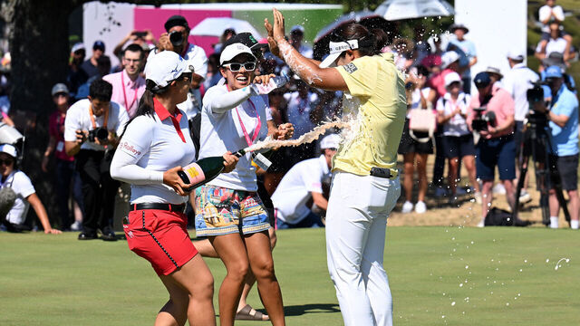 EVIAN-LES-BAINS, FRANCE - JULY 12: Haeran Ryu of South Korea is sprayed with champagne and water following victory on the 18th green following a playoff round during the final round of The Amundi Evian Championship 2026 at Evian Resort Golf Club on July 12, 2026 in Evian-les-Bains, France.