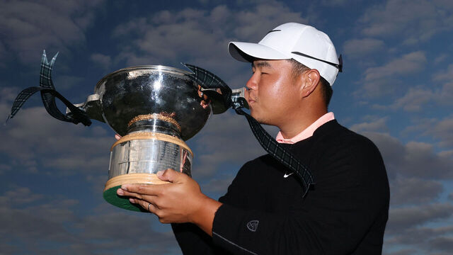 NORTH BERWICK, SCOTLAND - JULY 12: Tom Kim of South Korea kisses the trophy following victory on day four of the Genesis Scottish Open 2026 at The Renaissance Club on July 12, 2026 in North Berwick, Scotland.