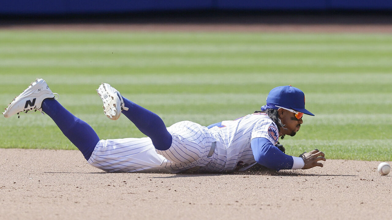 NEW YORK, NEW YORK - JULY 12: Francisco Lindor #12 of the New York Mets can't come up with the ball after a fielding error during the ninth inning against the Boston Red Sox at Citi Field on July 12, 2026 in New York City.