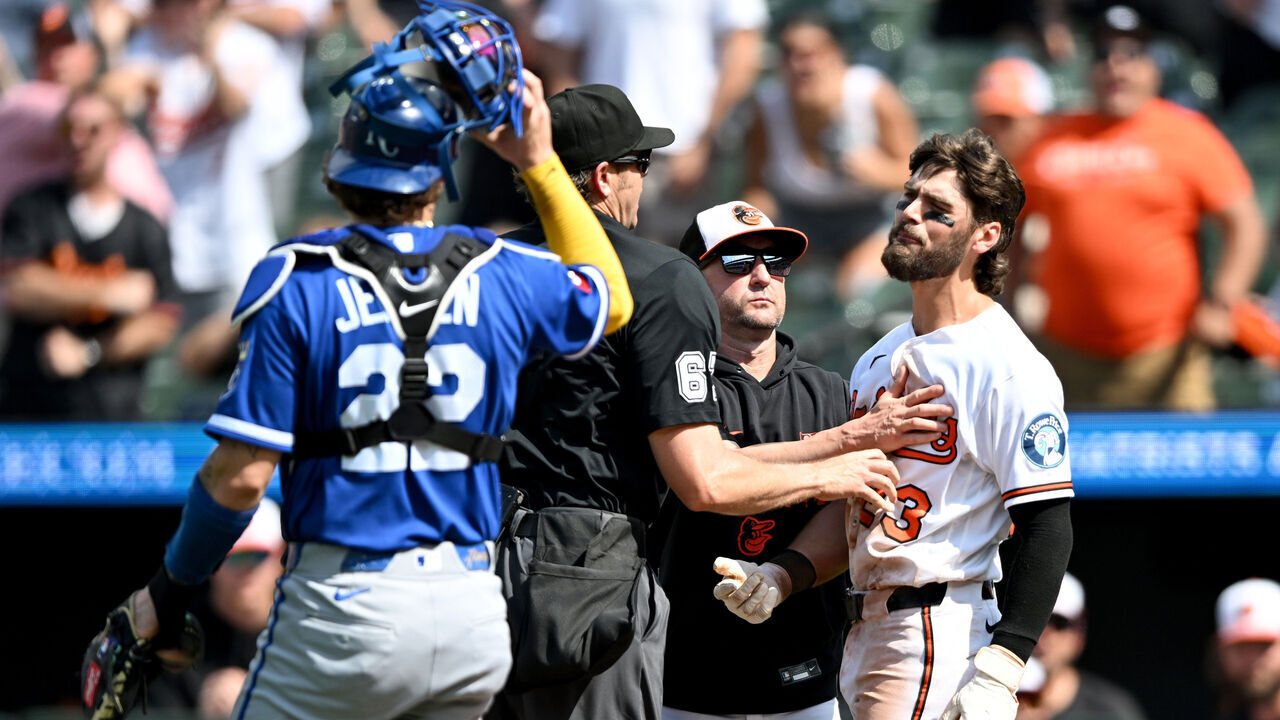 BALTIMORE, MARYLAND - JULY 12: Blaze Alexander #23 of the Baltimore Orioles is held back by manager Craig Albernaz #55 and home plate umpire Ryan Additon after being hit by a pitch in the seventh inning against the Kansas City Royals at Oriole Park at Camden Yards on July 12, 2026 in Baltimore, Maryland.