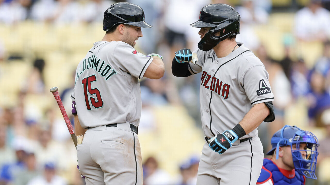 LOS ANGELES, CALIFORNIA - JULY 12: Tim Tawa #13 of the Arizona Diamondbacks celebrates with Ryan Waldschmidt #15 after hitting a home run during the ninth inning against the Los Angeles Dodgers at Dodger Stadium on July 12, 2026 in Los Angeles, California.