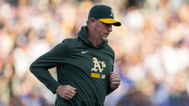 SACRAMENTO, CALIFORNIA - JUNE 29: Athletics Pitching Coach Scott Emerson #14 runs back to the dugout in the top of the second inning against the Los Angeles Dodgers at Sutter Health Park on June 29, 2026 in Sacramento, California.