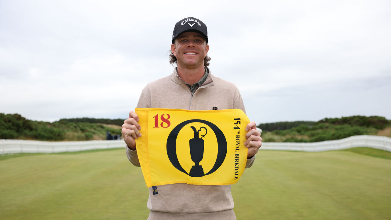 TROON, SCOTLAND - JUNE 30: Marcus Plunkett of The USA holds up The Open pin flag after qualifying for The 154th Open at Royal Birkdale at Dundonald Links Golf Course on June 30, 2026 in Troon, Scotland.