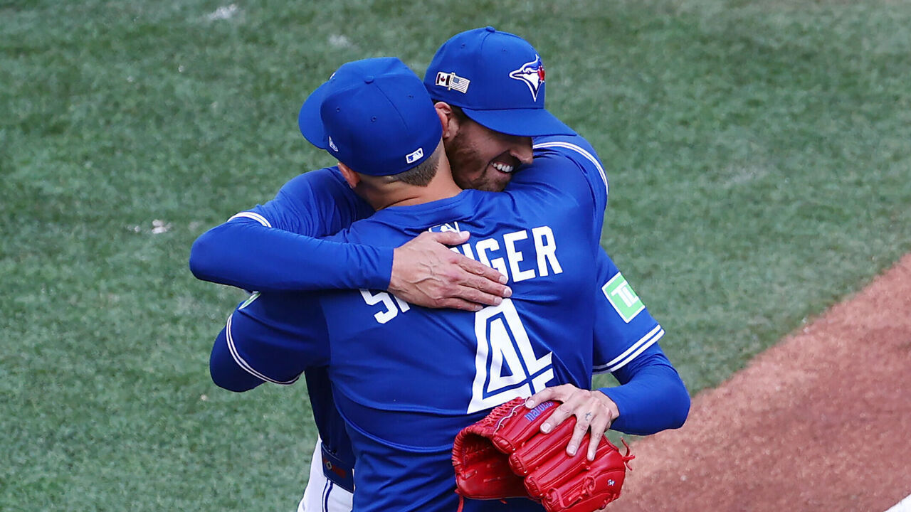TORONTO, ON - SEPTEMBER 11: Kevin Gausman #34 of the Toronto Blue Jays celebrates with George Springer #4 after pitching a 6-0 complete game shutout against the Houston Astros at Rogers Centre on September 11, 2025 in Toronto, Ontario, Canada.