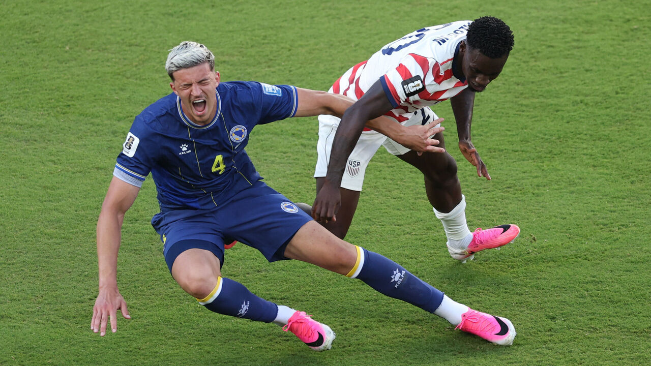 SANTA CLARA, CALIFORNIA - JULY 01: Folarin Balogun #20 of the United States fouls Tarik Muharemovic #4 of Bosnia and Herzegovina which is later reviewed by VAR and awarded as a red card foul a during the FIFA World Cup 2026 Round of 32 match between USA and Bosnia and Herzegovina at San Francisco Bay Area Stadium on July 01, 2026 in Santa Clara, California.