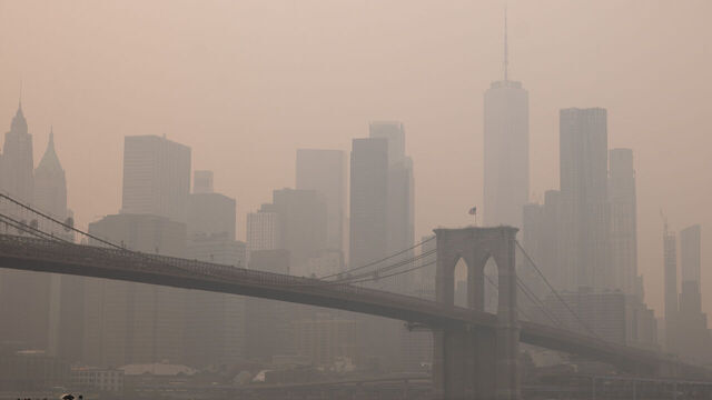 NEW YORK, NEW YORK - JULY 16: Haze from Canadian wildfires blankets the Manhattan skyline as seen on July 16, 2026 from the Dumbo neighborhood of the Brooklyn borough of New York City. New York City is under an Air Quality Health Advisory as the Canadian and Great Lakes wildfire smoke gradually moves through the area, creating a thick haze in the heat. New York City and much of the East Coast are experiencing temperatures with heat indexes over 100 degrees as the region confronts another heat wave.