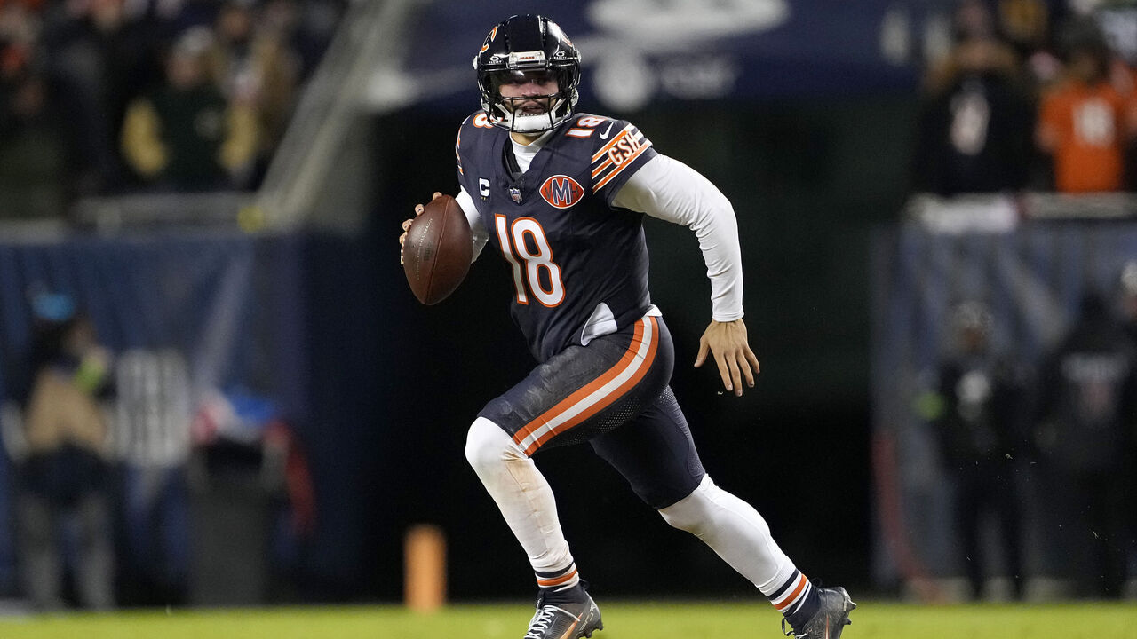 CHICAGO, ILLINOIS - JANUARY 10: Caleb Williams #18 of the Chicago Bears runs the ball against the Green Bay Packers during the second quarter in the NFC Wild Card Playoff game at Soldier Field on January 10, 2026 in Chicago, Illinois.