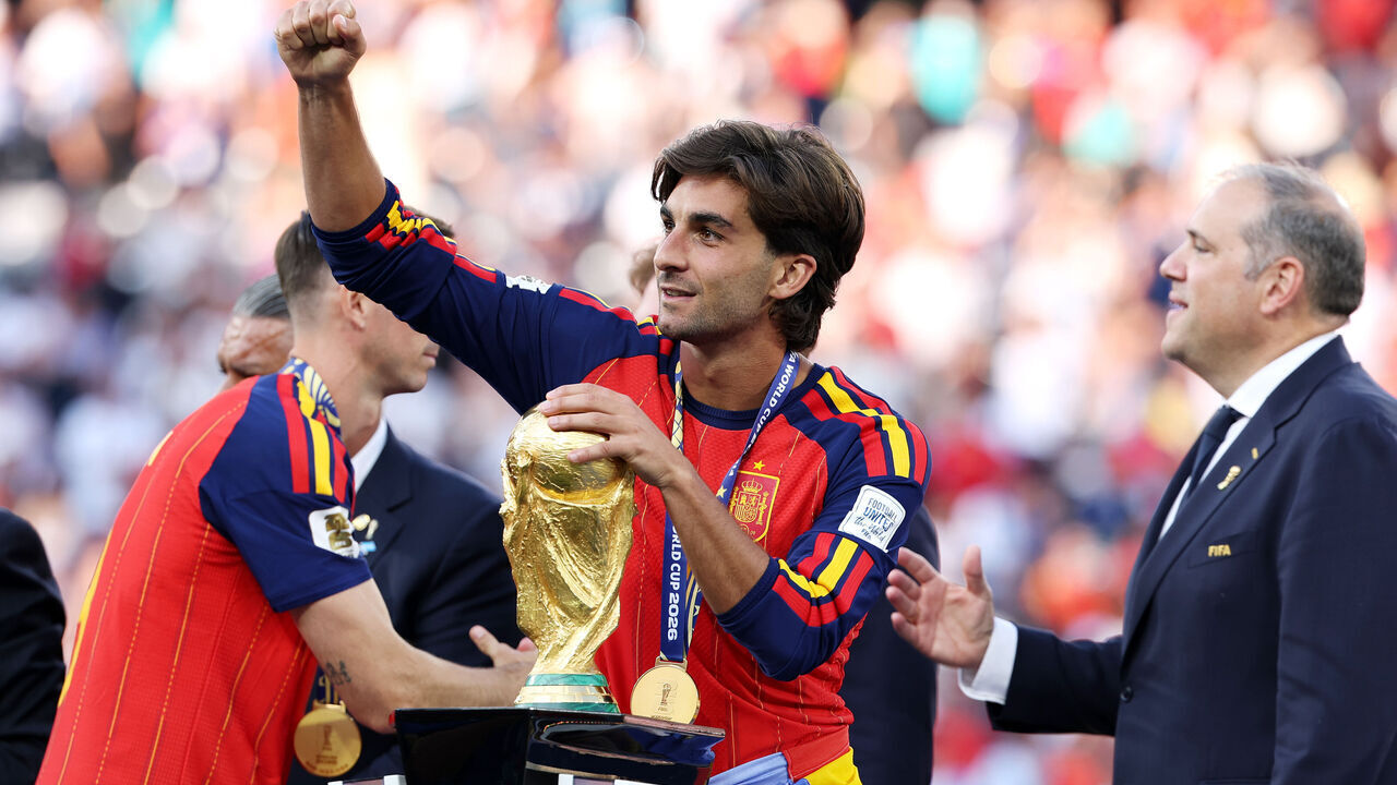 EAST RUTHERFORD, NEW JERSEY - JULY 19: Ferran Torres #7 of Spain celebrates with the FIFA World Cup Winner's Trophy after receiving his medal during the FIFA World Cup 2026 Final match between Spain and Argentina at New York New Jersey Stadium on July 19, 2026 in East Rutherford, New Jersey.