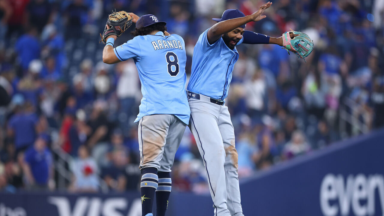 TORONTO, ON - JULY 20: Junior Caminero #13 and Jonathan Aranda #8 of the Tampa Bay Rays celebrate after the final out of a game against the Toronto Blue Jays at Rogers Centre on July 20, 2026 in Toronto, Ontario, Canada.