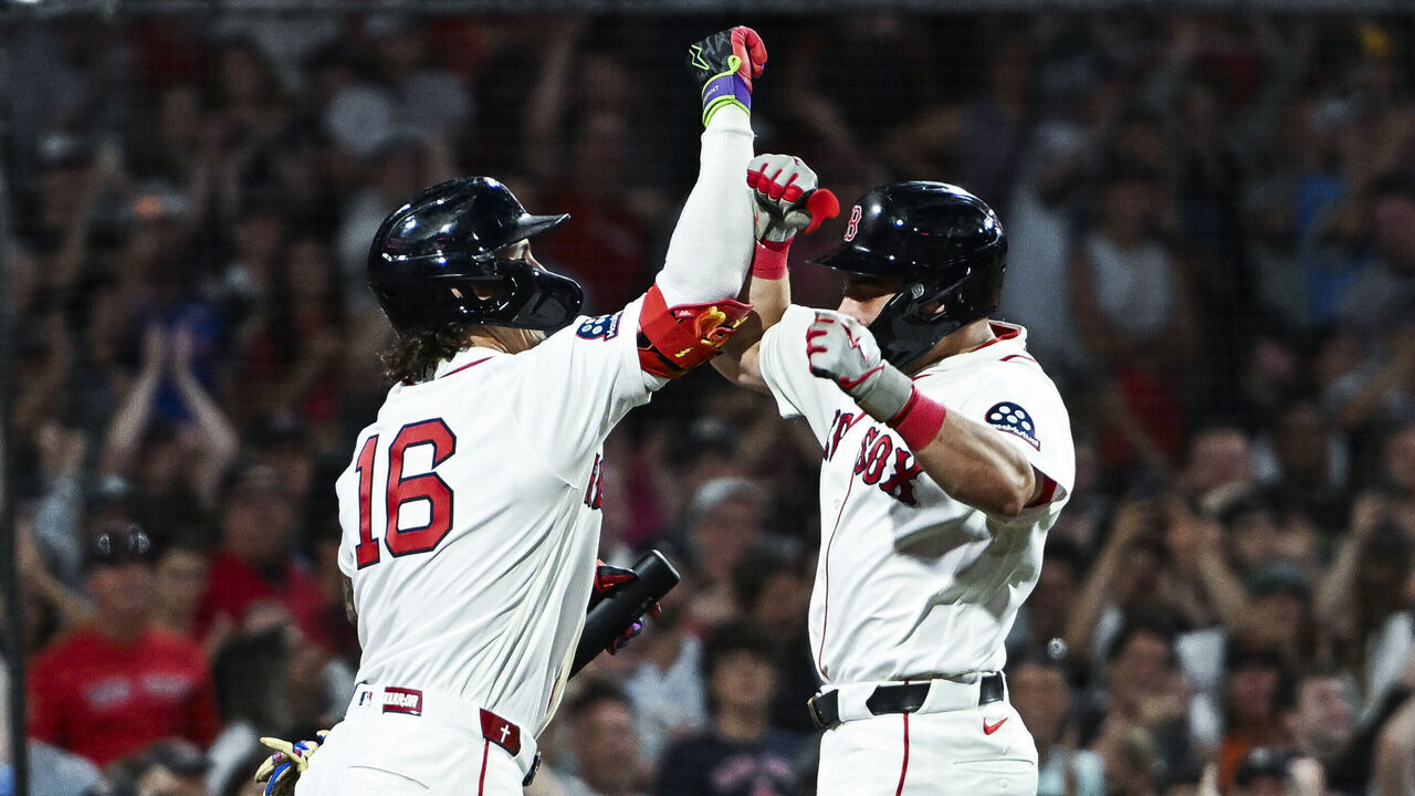 BOSTON, MASSACHUSETTS - JULY 20: Jarren Duran #16 of the Boston Red Sox greets Caleb Durbin #5 at home plate after hitting a solo home run to take the lead in the eighth inning against the Baltimore Orioles at Fenway Park on July 20, 2026 in Boston, Massachusetts.