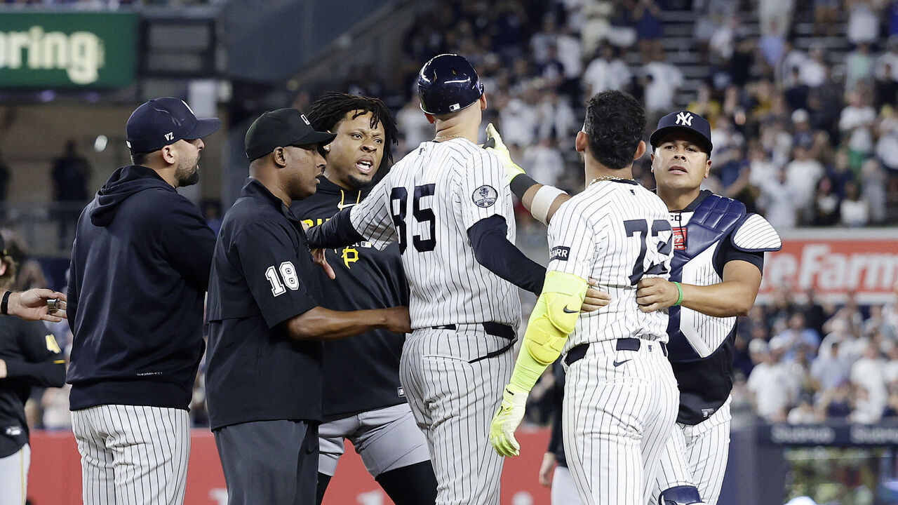 NEW YORK, NEW YORK - JULY 20: Jose Caballero #72 of the New York Yankees is restrained after an altercation against the Pittsburgh Pirates after the eighth inning at Yankee Stadium on July 20, 2026 in New York City.