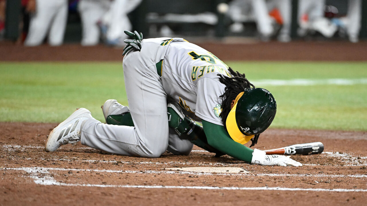 PHOENIX, ARIZONA - JULY 20: Joshua Kuroda-Grauer #44 of the Athletics lays in the batters box after getting hit by a foul ball against the Arizona Diamondbacks during the fifth inning at Chase Field on July 20, 2026 in Phoenix, Arizona.